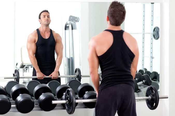 Man Weightlifting In Front Of A Mirror