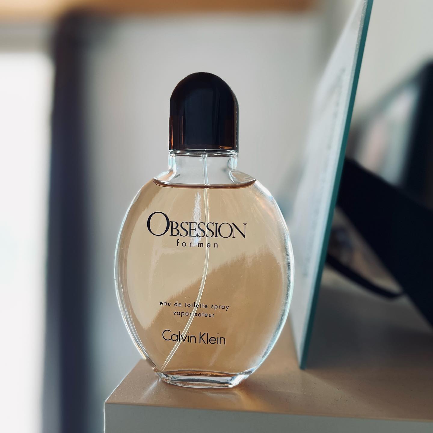 a bottle of Calvin Klein Obsession on the Table