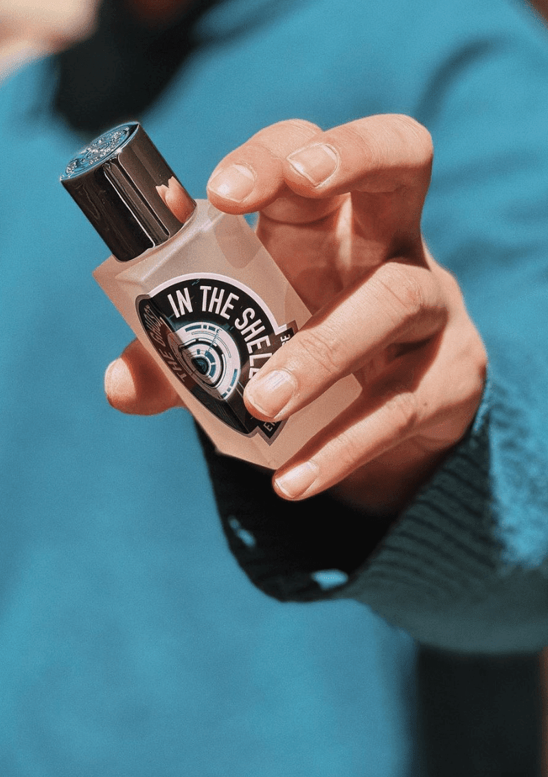 Hand holding a cologne bottle 