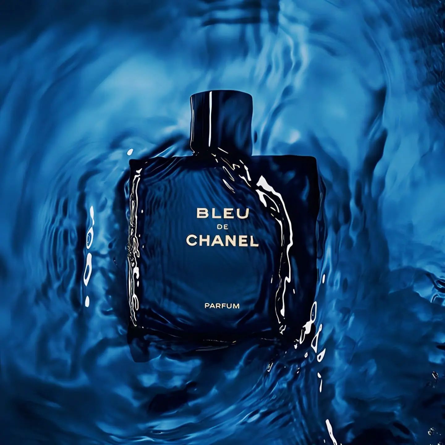 a bottle of Blue De Chanel floating in the water