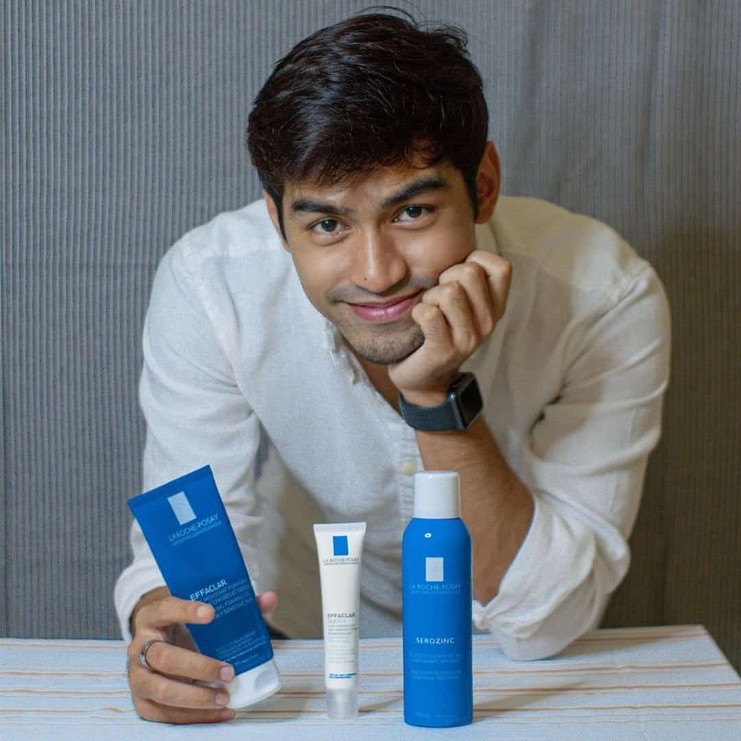 man holding a facial cleanser