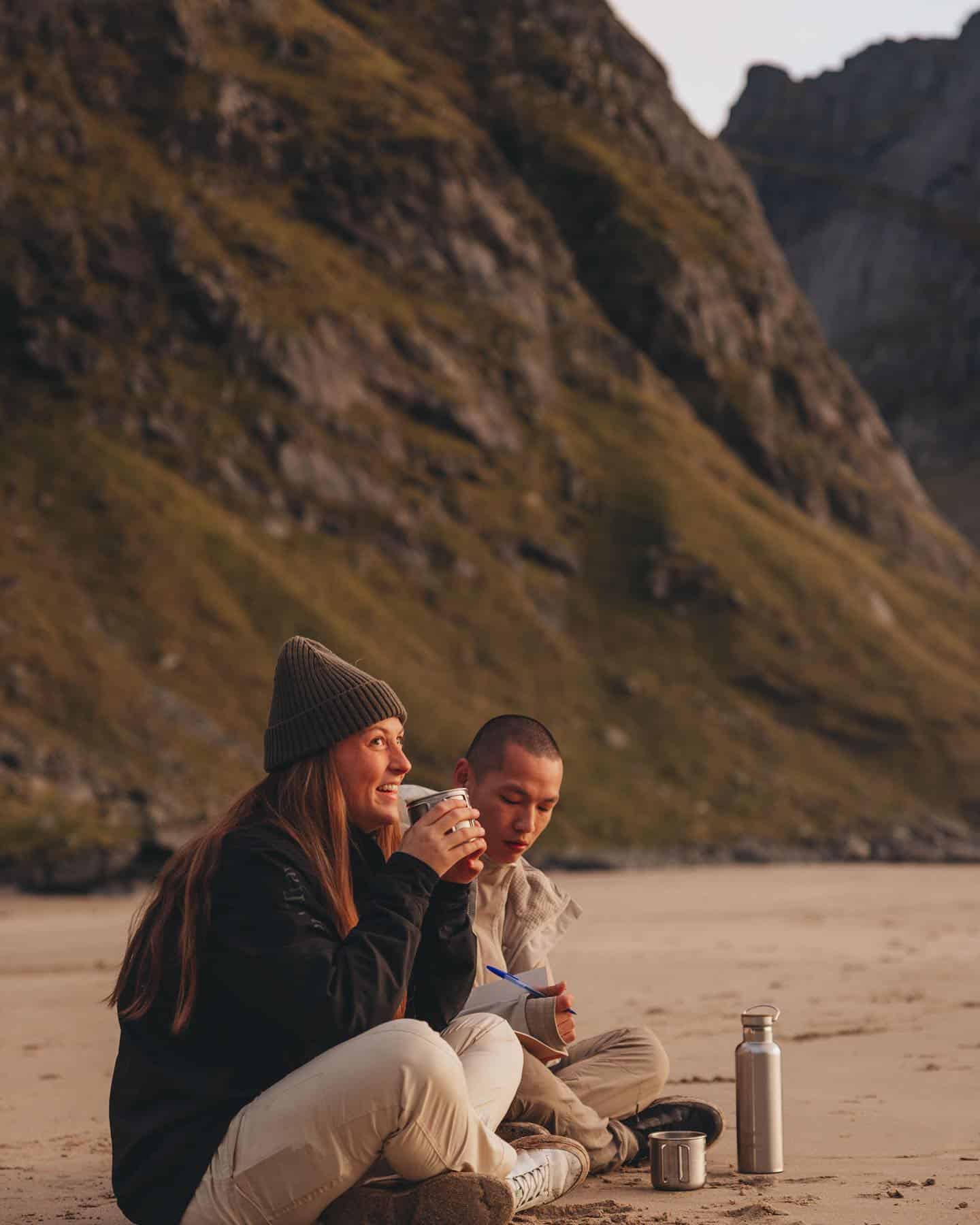 couples having a hot drink by the sea