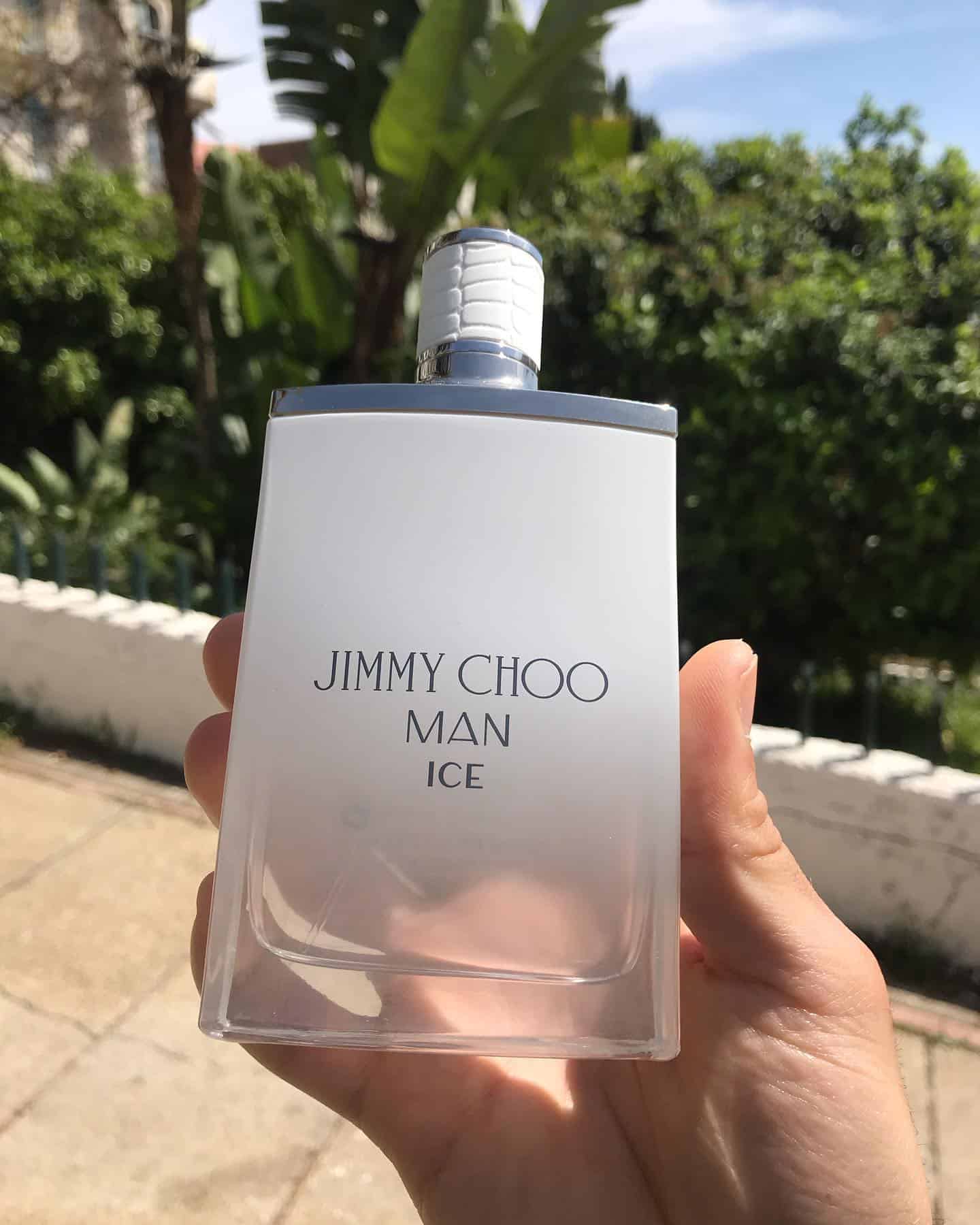 holding a bottle of jimmy choo man ice cologne