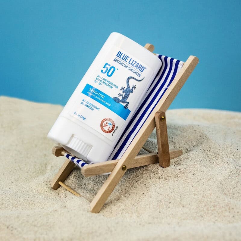 the blue lizard sunscreen stick on a mini folding chair